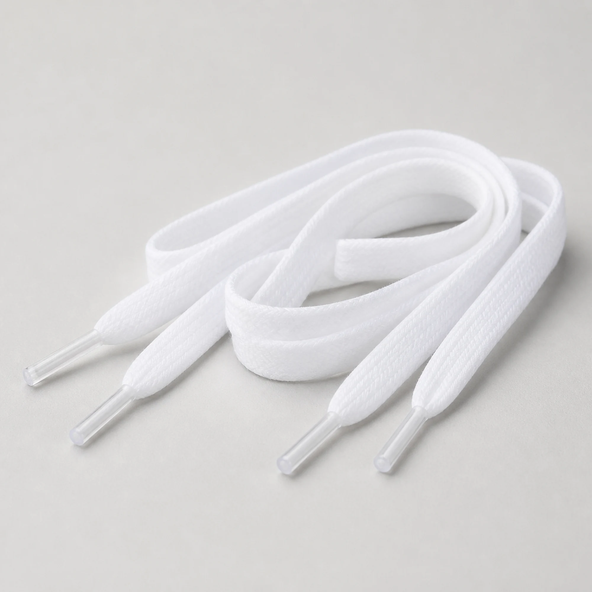 Vista lateral de cordones planos blancos con puntas transparentes