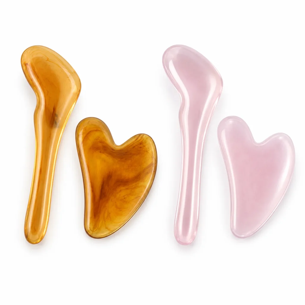 Set de masajeadores gua sha de dos piezas en colores ámbar y rosado